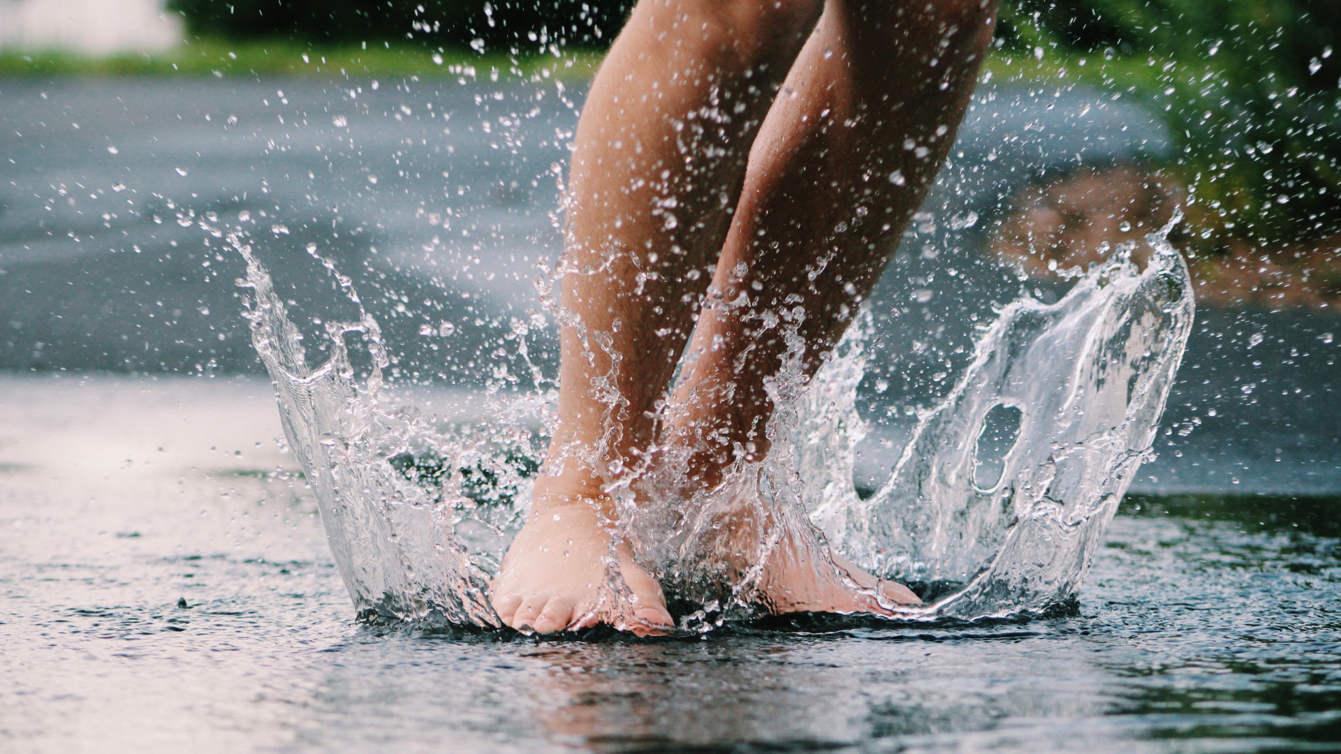 bare feet splashing in a puddle